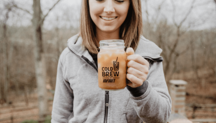 Woman enjoying INFINIT cold brew